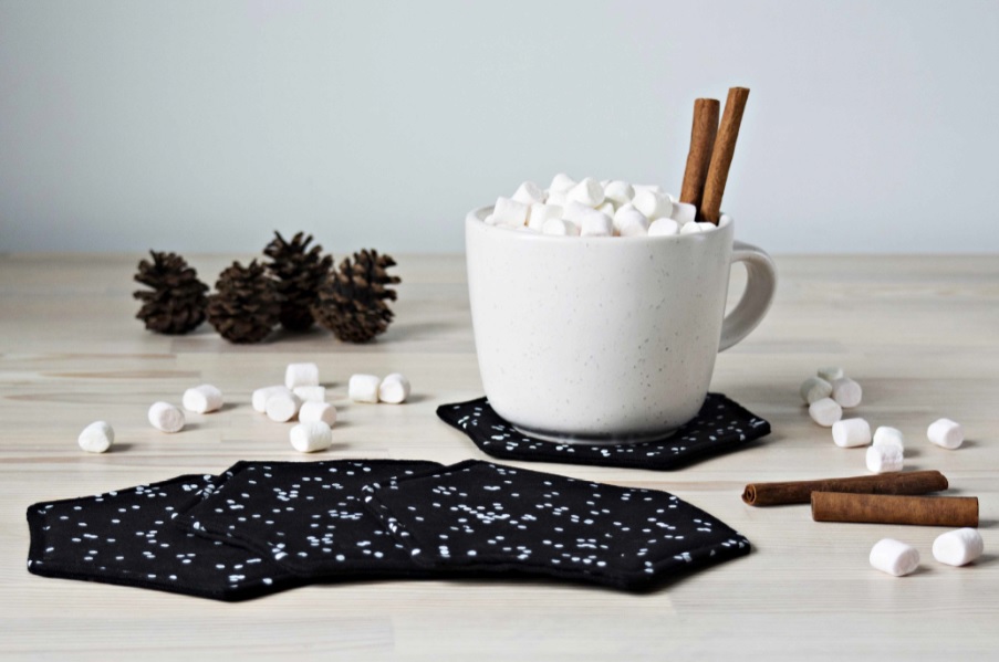 Black Fabric Coasters And White Cup With Marshmallows And Cinnam